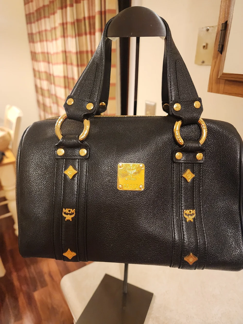 MCM Black Leather Boston Bag featuring polished gold-tone hardware
